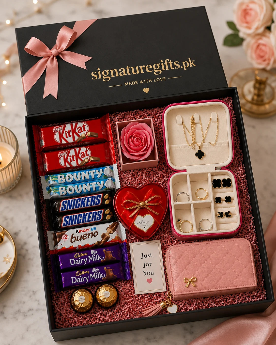 A curated gift box set from signaturegifts.pk displayed open on a marble surface.